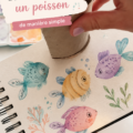Poisson coloré peint à la main, exposé sur un mur décoratif.