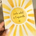 Carte soleil réalisée en aquarelle, avec des couleurs vibrantes et des détails délicats.
